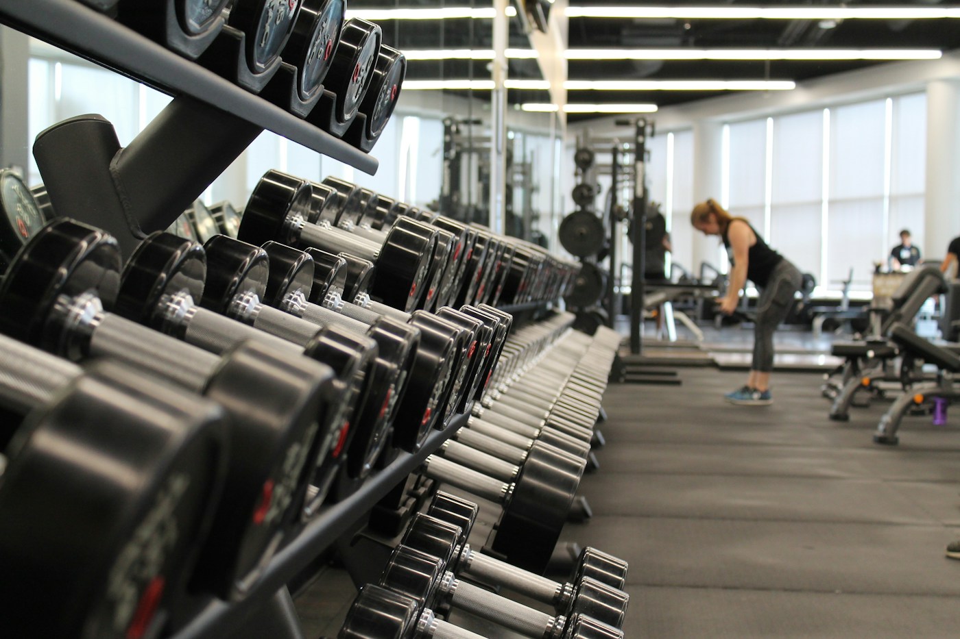 Barbells and strength training equipment in a gym